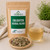 Bulk Enlighten Herbal Blend in The Tea Hut certified organic kraft pouch, with loose brahmi, ashwagandha, gotu kola, Siberian ginseng, honeybush, hibiscus, soursop leaf and paw paw leaf beside a pale golden brewed cup.
