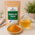 Organic Turmeric Root Powder in The Tea Hut certified organic kraft pouch, with loose golden turmeric powder beside a warm brewed cup.