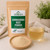 Bulk Ashwagandha Root Powder in The Tea Hut certified organic kraft pouch, with loose ashwagandha root powder beside a warm golden brewed cup.