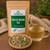 Organic Field of Dreams Tea in The Tea Hut certified organic kraft pouch, with chamomile, lemon balm, lavender, spearmint and passionflower beside a brewed cup.