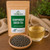 Organic Gunpowder Green Tea in The Tea Hut certified organic kraft pouch, with rolled gunpowder green tea leaves beside a golden brewed cup.