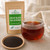 Certified organic Bulk Decaf Black Tea (Strong) by The Tea Hut, shown with a strong amber infusion and fine fannings-grade certified organic decaffeinated black tea.