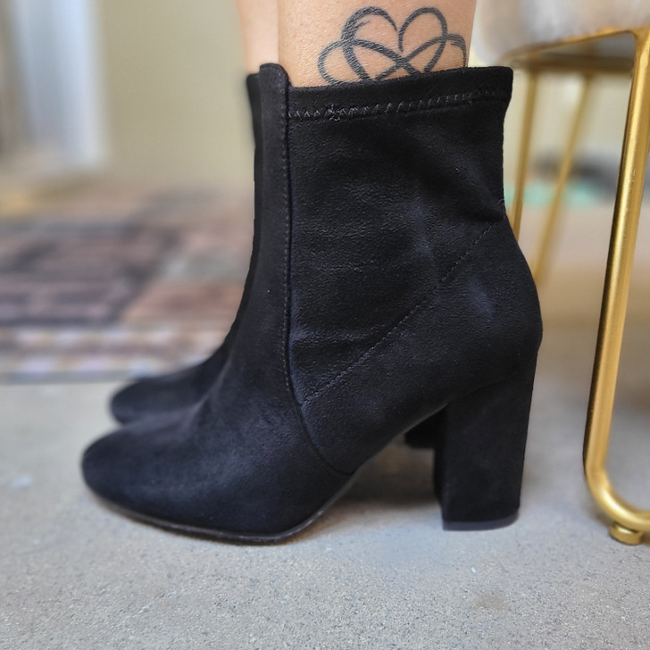 Stylish women's black suede ankle boots, showcasing sleek design and chunky heel that provides height while likely offering stability and comfort.