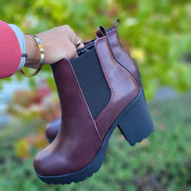 Elegant Wine faux leather ankle boots with elastic side panels, pull tabs, and rugged soles, blending style and comfort for a versatile footwear option