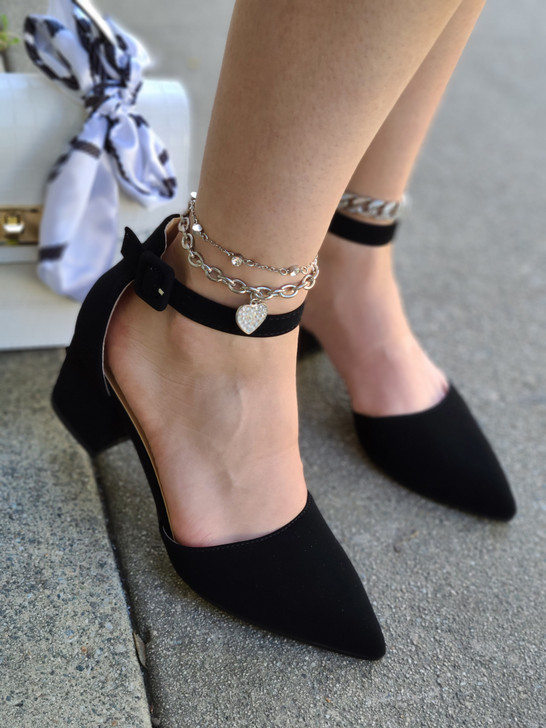 Stylish and comfortable Black suede single sole heels. These heels have a thin sole that gives them a sleek and elegant look. They also feature an ankle strap that secures your foot and adds some flair.