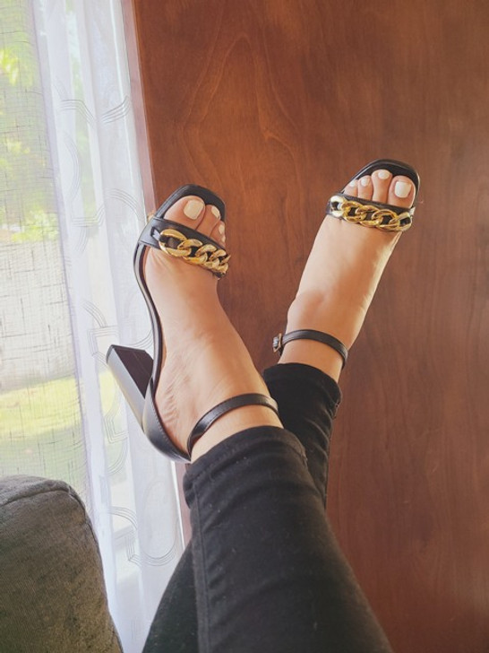Step into style with our elegant black high-heeled sandal. Featuring a gold chain embellishment and a secure ankle strap with buckle closure, this shoe offers both comfort and a modern look. Perfect for any occasion, experience the blend of style and comfort today