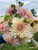 A bouquet of dahlia Cafe au Lait in the flower field at Muddy Acres Flower Farm
