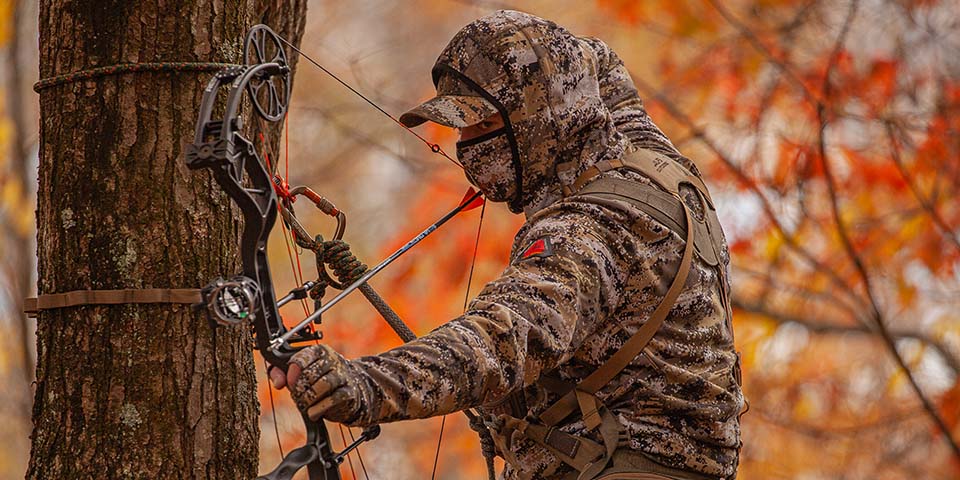 Hunter dressed in camo for early season archery deer hunting