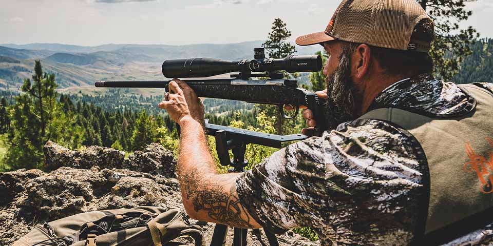 Man dressed in camouflage shirt and pants for hunting when its hot and sunny