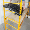 MetalTech I-CISTR Tool Shelf, a storage organizer by MetalTech, in use on a yellow scaffold.