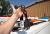 Prime Design ACC-8000 Retractable Ratchet Tie-Down, black ratchet tie-down held by a hand.