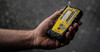 Stabila 7360 REC 500 RG rotary laser receiver, yellow and black, in a hand under water spray.