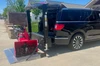 Liftgator VanGator Hitch-Mounted Liftgate in black color with red liftgate attachment installed on SUV.