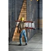 Werner D6200-3 fiberglass extension ladder, 3-section, 300 lbs rated, carried by worker.