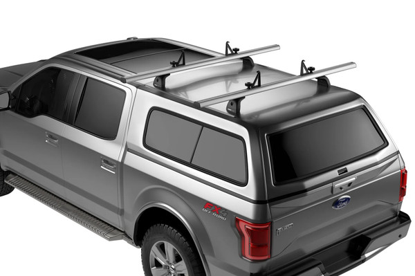 Thule TracRac Cap Rack, silver, aerodynamic design on a truck cap.