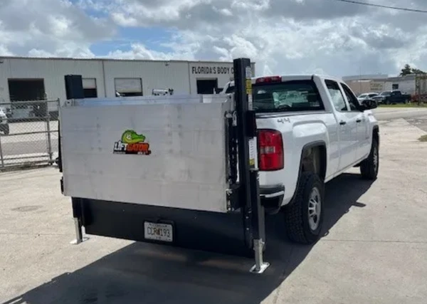 Liftgator TruckGator Hitch-Mounted Liftgate on white pickup truck with logo displayed on back gate.