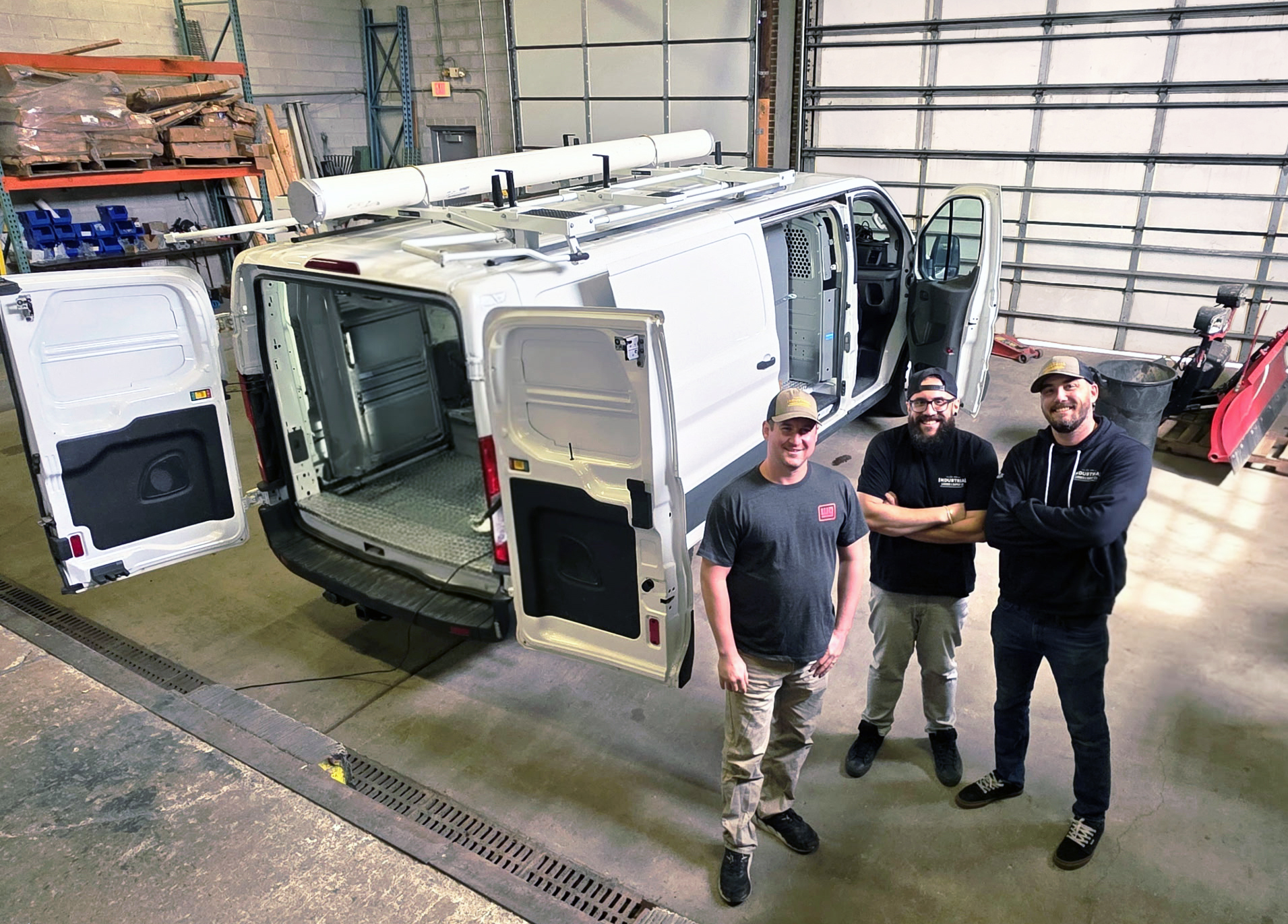 Photo of van installation in garage with ILS team members