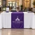 Purple printed table runner on a church lobby welcome table