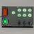 Sophisticated metal switch panel with a red toggle safety cover, a prominent green ENGINE START button, multiple illuminated metal switches. The panel&#39;s design is both functional and aesthetically modern