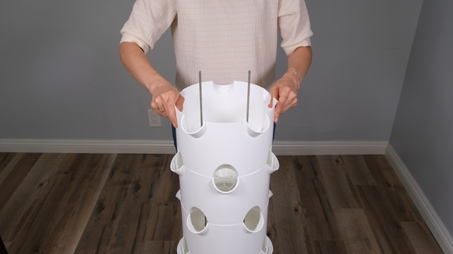 woman assembling her tower garden
