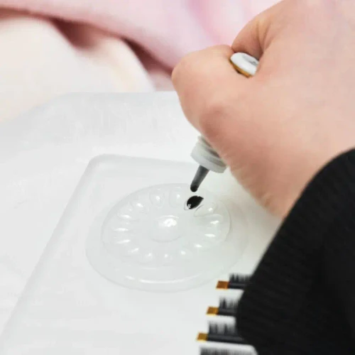 Self-adhesive base for glue drops