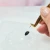 Self-adhesive base for glue drops