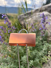Mini E-Series copper garden marker with compact angled nameplate and galvanized wire legs – perfect for labeling seedlings, small herbs, or container plants. Lightweight yet durable, rustproof, and weather-resistant. Made in the USA for gardeners who need clear, long-lasting plant tags.