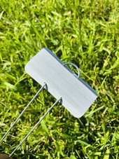 Close-up of E-Series Zinc Garden Marker with durable galvanized steel wire legs and weather-resistant zinc nameplate – ideal for outdoor plant labeling in vegetable gardens, herb beds, flower plots, and botanical displays. Rustproof and reusable metal garden marker proudly made in the USA.