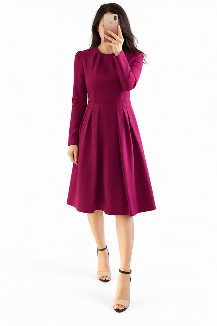 Model wearing a raspberry pink long puff-sleeve pleated fit-and-flare dress