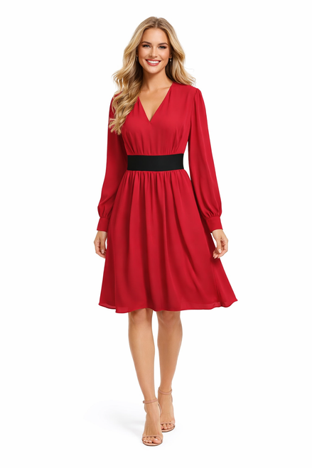 Model wearing a red V-neck pleated dress with long sleeves, ruffled shoulders and a black contrast waistband