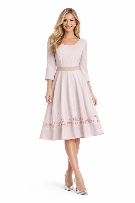 Model wearing a pale blush fit-and-flare dress with three-quarter sleeves, a contrast waistband and floral embroidery along the skirt