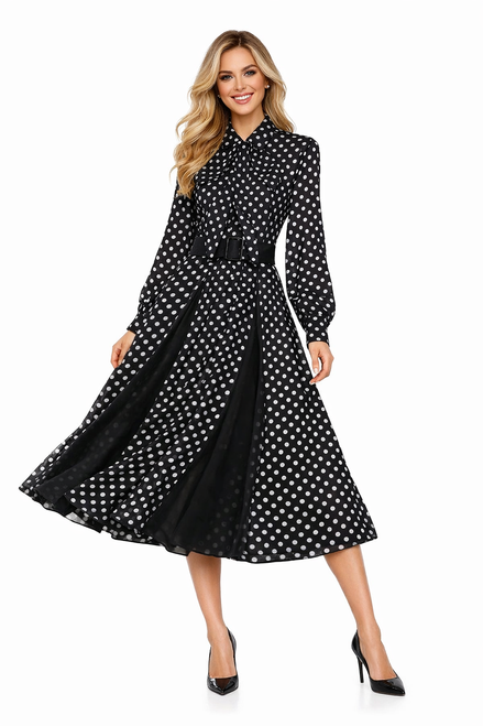 Model wearing a black polka dot chiffon shirt dress with sheer long sleeves, a pleated skirt insert and a detachable tie belt