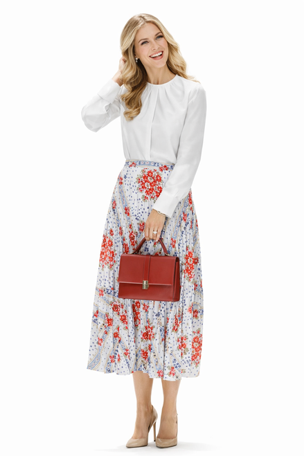 Model wearing a white pintuck blouse and floral pleated midi skirt set