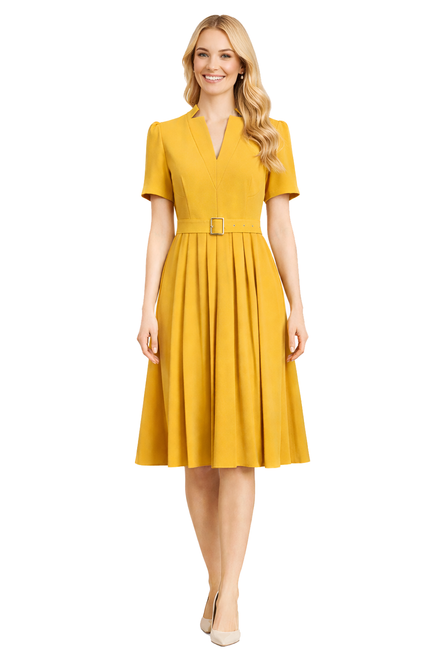 Model wearing a ginger yellow pleated midi dress with puff sleeves, a notched neckline and matching belt