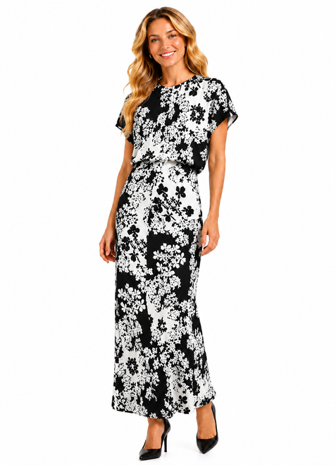 Model wearing a floral print A-line maxi dress with a round neckline, short sleeves and a ruched fitted waist