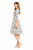 Model wearing a white and black polka dot midi dress with a square neckline, fitted three-quarter sleeves and flared skirt