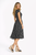 Model wearing a black and white leopard print midi dress with a keyhole neckline and elasticated waist