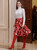 Queen Letizia of Spain in white knit top and abstract red skirt