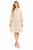 Model wearing a beige brocatelle tunic-style A-line dress with a pointed collar, elbow-length sleeves and oversized decorative buttons