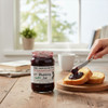 Seedless blackberry jam on toast with The Dutch Kettle No Sugar Added Blackberry Seedless Jam jar on a breakfast table.