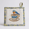 Pretty flower pattern border and back of a quilted Potholder/Hot Pad with a lovely embroidered bluebird on a teacup. Harvest Array /delivers Heritage to You.