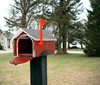 Red Wooden Covered Bridge Mailboxes with the front door open