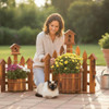 Lady planting her flowers in the Amish Made Corner Picket Fence Planter with a Birdhouse