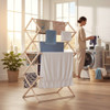 48 inch wooden folding clothes drying rack in laundry room with towels and clothing