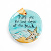 Hand-painted ornament with a starfish and beach scene, featuring the quote 'There are no bad days at the beach.' 3.5' in diameter.