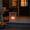 Light the way for your  little trick-or-treaters or fall party guests with this Rustic Wooden LED Pumpkin Lantern placed on the edge of the porch near the steps.