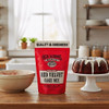 A package of Old School Brand Red Velvet Cake Mix on a wooden kitchen counter between a mixing bowl and a finished Red Velvet Bundt  with frosting. Yum!