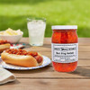 Annie's Kitchen Amish-made Hot Dog Relish on a picnic table with a hotdog, lemonade and other condiments on a bright summer day.