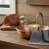 American Heartland 2 oz. mini Shea Butter Soap in a copper sink in a masculine guest bathroom.