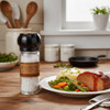 A country kitchen setting with a plate of meatloaf, mashed potatoes, and mixed vegetables next to a J.Q. Dickinson Salt Works Salt Grinder.